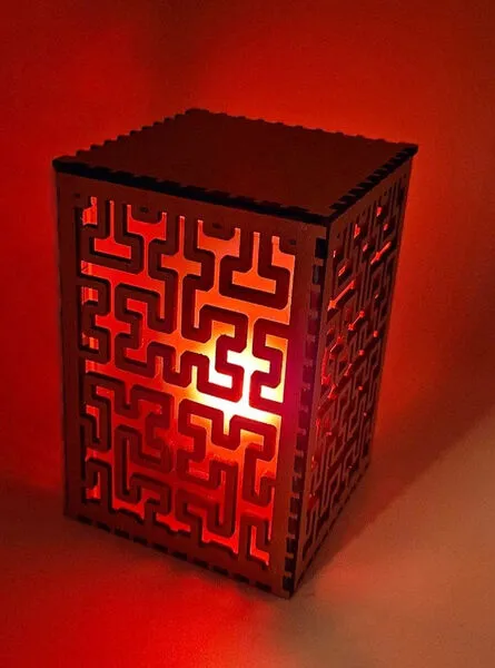 Laser cut lantern box with Hilbert curve fill pattern glowing red