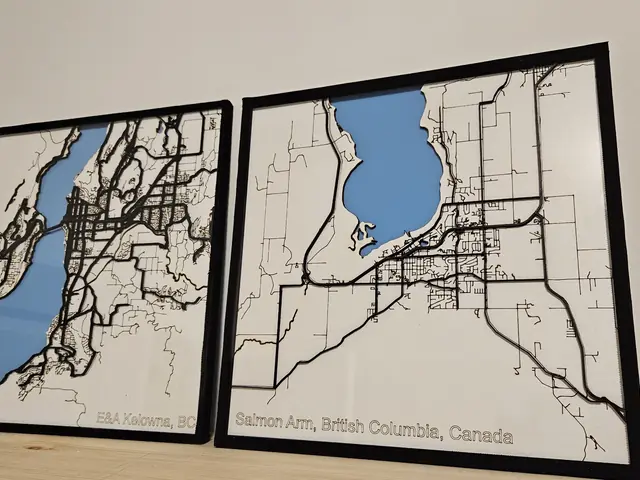 Two framed city maps with layered streets and blue water