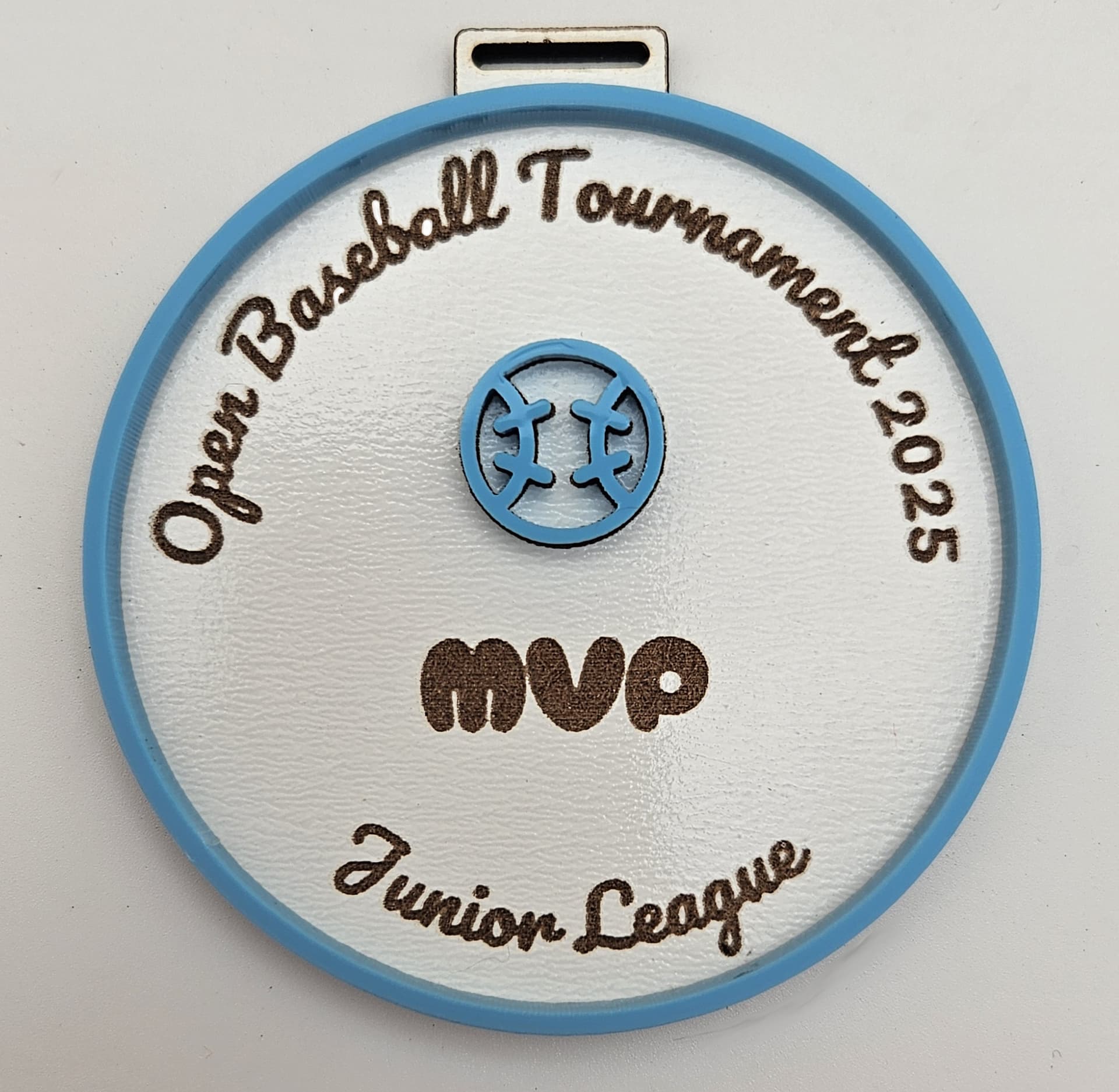 Medal made with blue pastel acrylic showing sports design