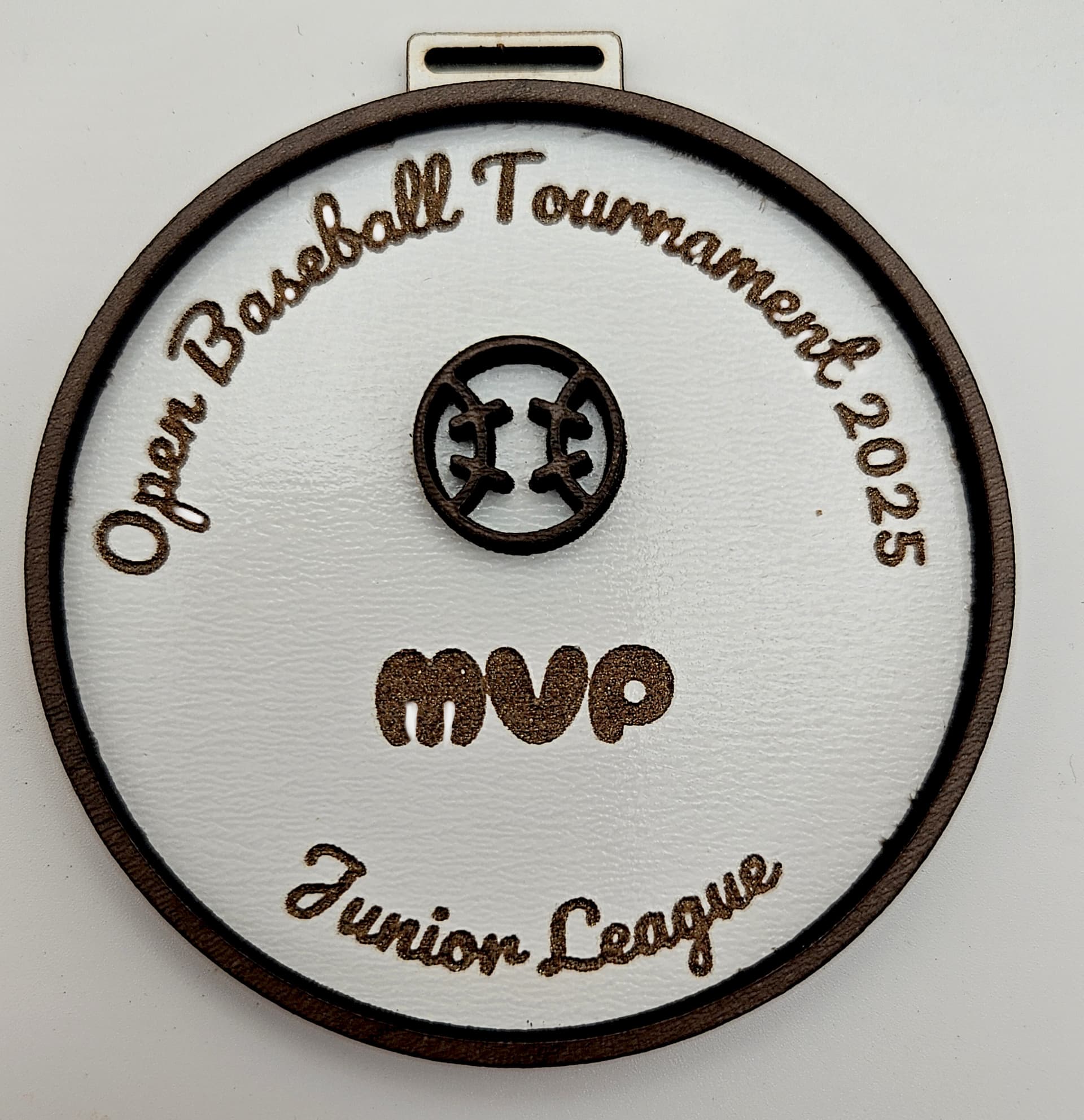 Medal made with walnut plywood showing elegant wood finish